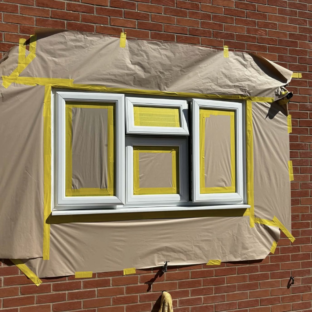 Close-up of a UPVC window precisely masked before spray application