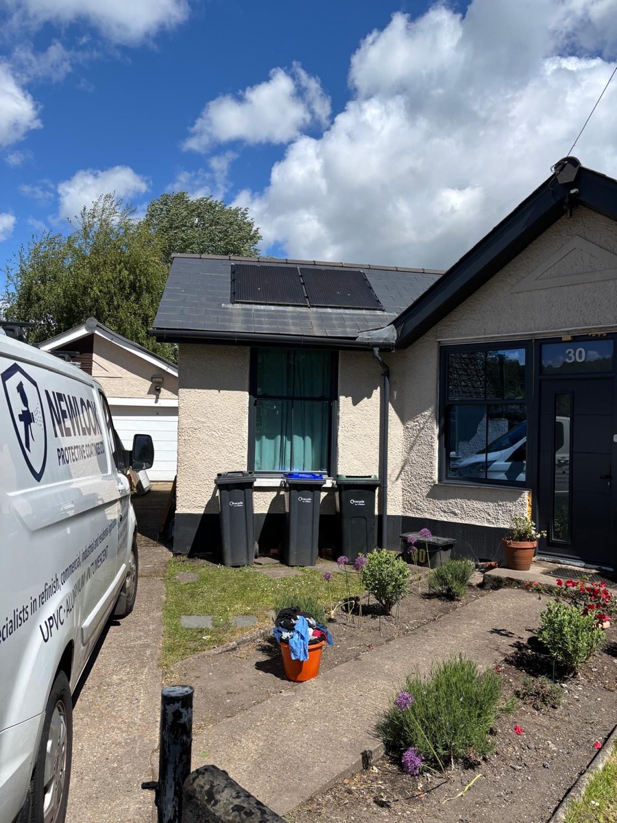Bungalow with anthracite grey sprayed UPVC windows and front door, Newlook Protective Coatings van on the driveway